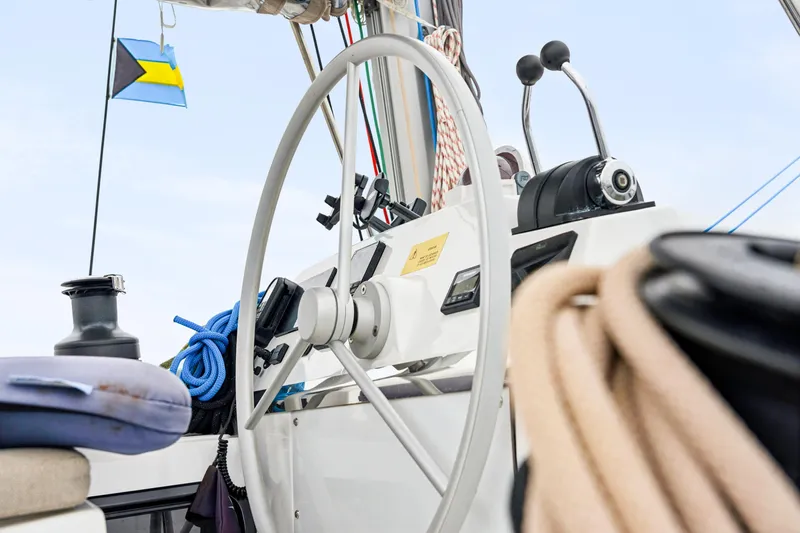 Slide: The Image of Steering wheel of 2023 Bali 4.2 yacht with nautical equipment and flag. - 32