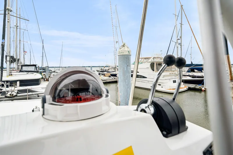 Slide: The Image of 2023 Bali 4.2 yacht controls with marina view, featuring various docked boats. - 33