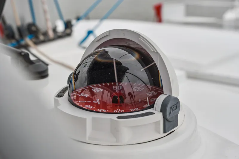 Slide: The Image of Close-up of a 2023 Bali 4.2 yacht compass, featuring a red dial. - 37