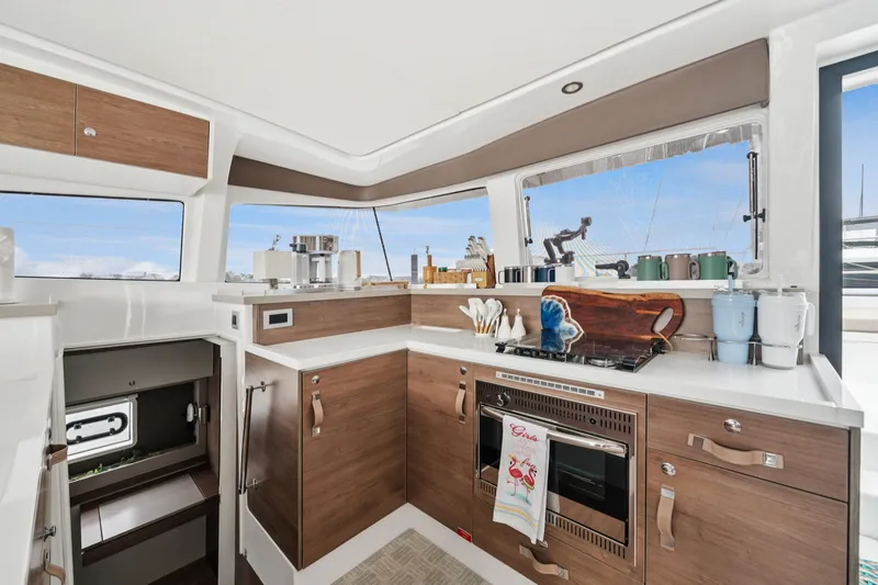 Slide: The Image of Modern kitchen interior on 2023 Bali 4.2 yacht, featuring wood cabinetry and ocean views. - 50