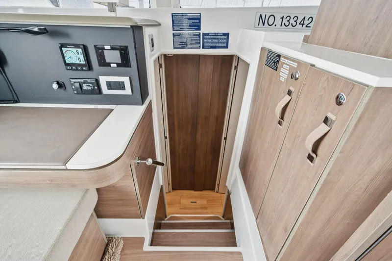Slide: The Image of Interior of 2023 Bali 4.2 yacht, featuring control panel and wooden cabinetry. - 69