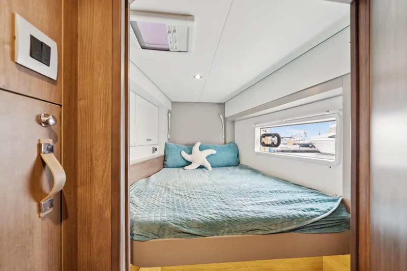 Slide: The Image of Cozy bedroom in 2023 Bali 4.2 yacht with teal bedding and starfish pillow. - 78