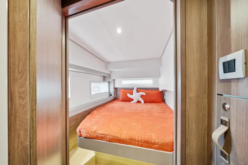 Slide: The Image of Cozy bedroom in 2023 Bali 4.2 yacht with orange bedding and starfish pillow. - 79