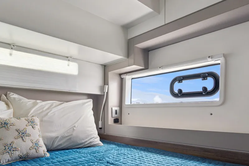Slide: The Image of Cozy interior cabin of 2023 Bali 4.2 yacht with window view and starfish pillow. - 88