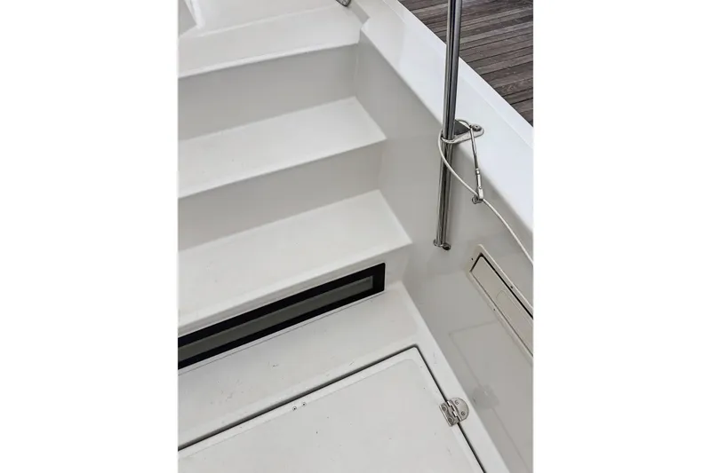 Slide: The Image of Staircase and deck area of 2023 Bali 4.2 boat, featuring sleek white design. - 90