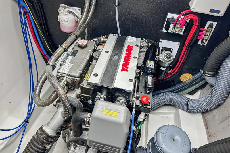 Slide: The Image of Engine compartment of a 2023 Bali 4.2, featuring a Yanmar engine with visible wiring and hoses. - 91