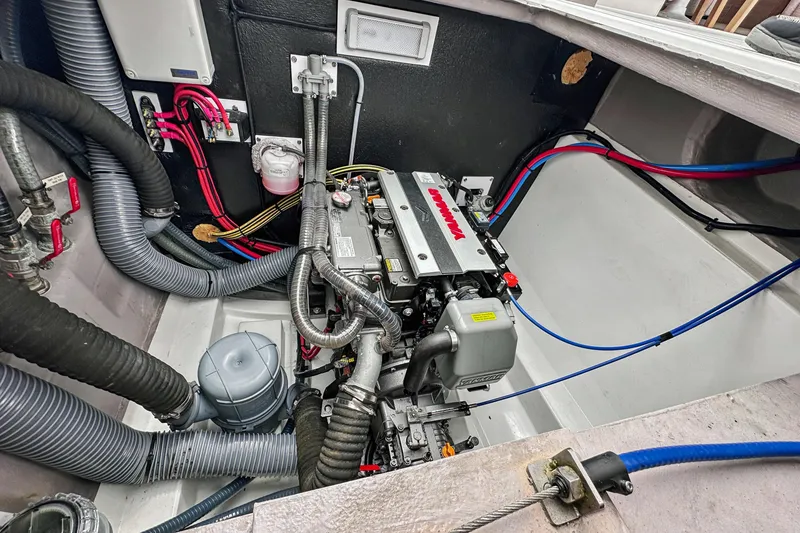 Slide: The Image of Engine compartment of 2023 Bali 4.2 boat, featuring Yanmar engine and various hoses. - 93