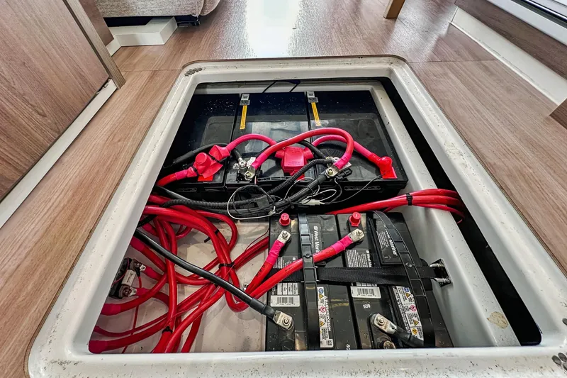 Slide: The Image of Battery compartment of 2023 Bali 4.2 with red cables and secure connections. - 94