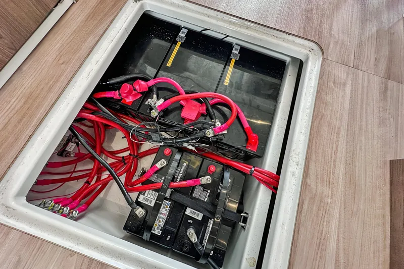 Slide: The Image of Battery compartment of a 2023 Bali 4.2 with red cables and connections. - 95