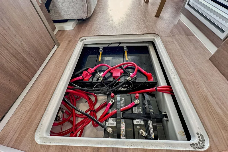 Slide: The Image of 2023 Bali 4.2 battery compartment with red cables and secure connections. - 96