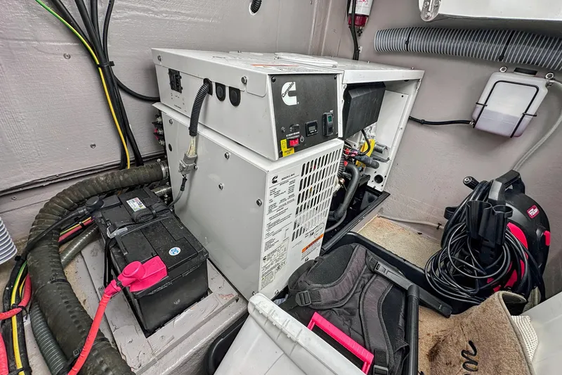 Slide: The Image of Electrical system in a 2023 Bali 4.2 boat, featuring a generator and battery setup. - 98