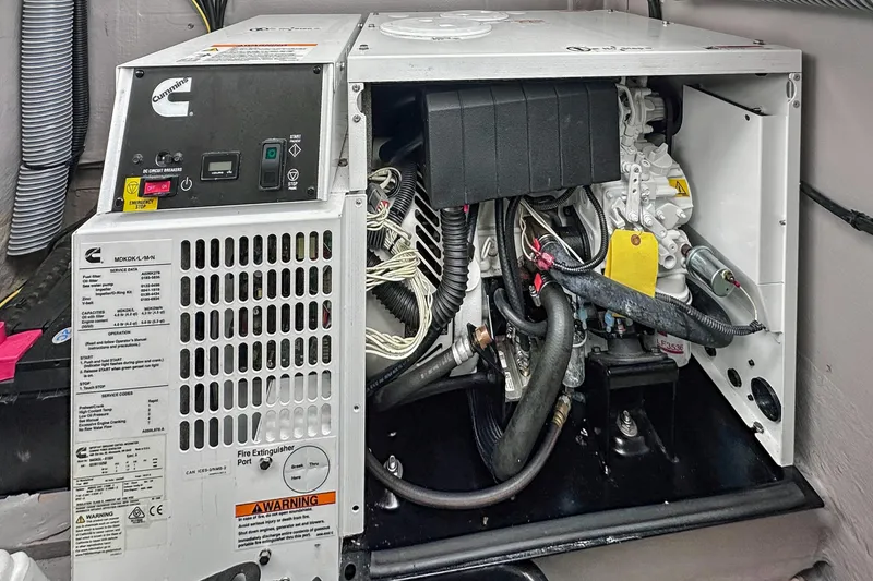 Slide: The Image of Cummins generator inside a Bali 4.2 model, 2023, showing engine components and control panel. - 99