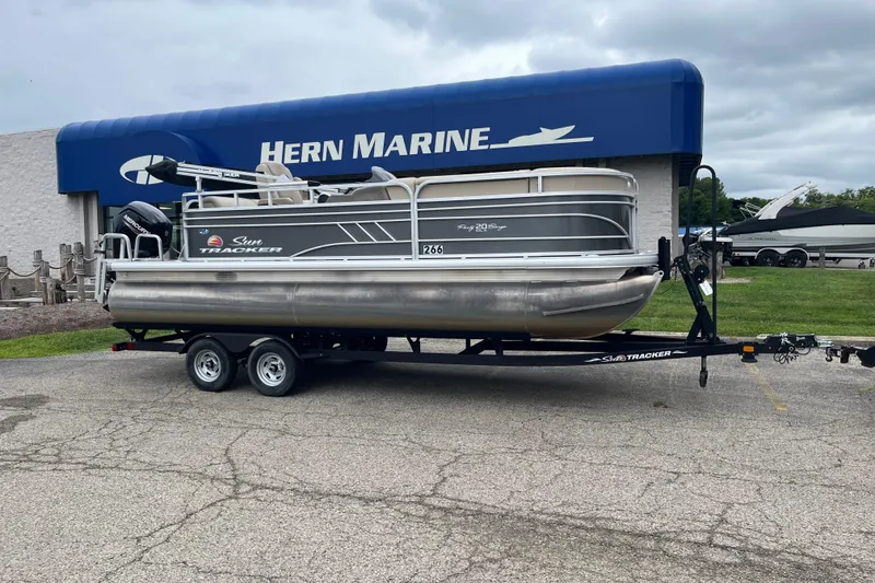The Image of 2022 Sun Tracker Party Barge 20 DLX pontoon boat on trailer at Hern Marine dealership. - 0