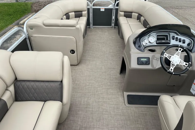 Slide: The Image of 2022 Sun Tracker Party Barge 20 DLX interior with plush seating and modern helm. - 10