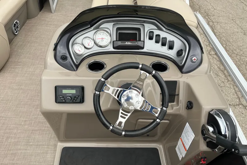 Slide: The Image of 2022 Sun Tracker Party Barge 20 DLX dashboard with steering wheel and controls. - 11