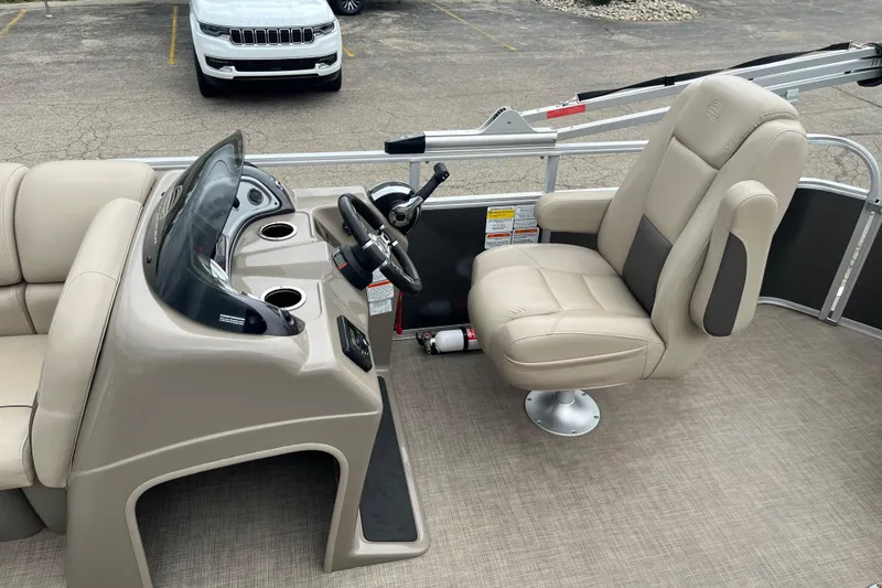 Slide: The Image of 2022 Sun Tracker Party Barge 20 DLX interior with steering console and captain's chair. - 14