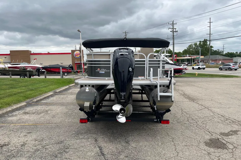 Slide: The Image of 2022 Sun Tracker Party Barge 20 DLX pontoon boat in parking lot, overcast sky. - 4