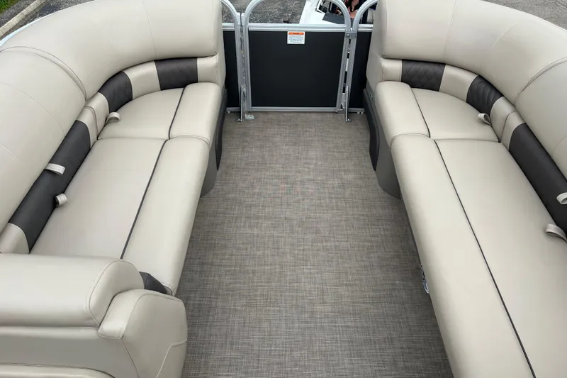 Slide: The Image of 2022 Sun Tracker Party Barge 20 DLX interior with beige seating and spacious layout. - 6