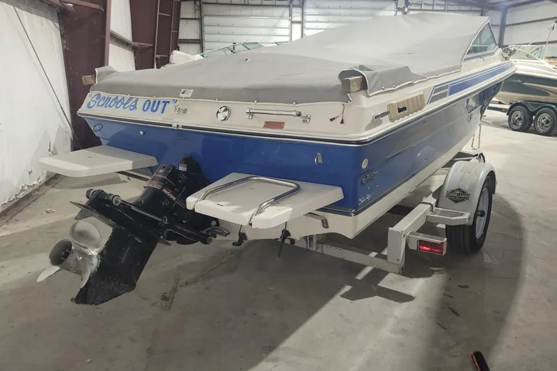 Slide: The Image of 1986 Sea Ray Seville 18 Bowrider boat in storage, covered and on a trailer. - 2