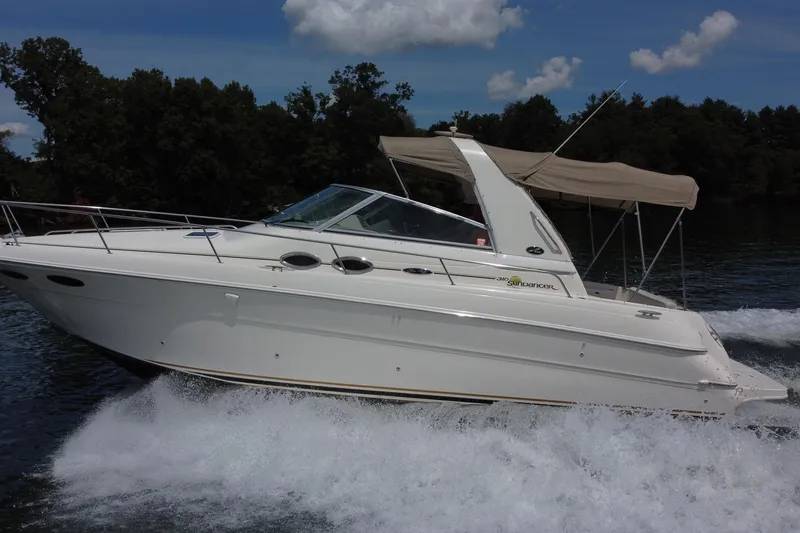 Slide: The Image of 2001 Sea Ray 310 Sundancer cruising on a lake under a clear blue sky. - 5
