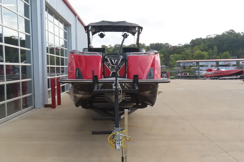 Slide: The Image of 2024 Trifecta 25Sport RF9 DC 3.0 Plus pontoon boat in a dealership lot. - 3