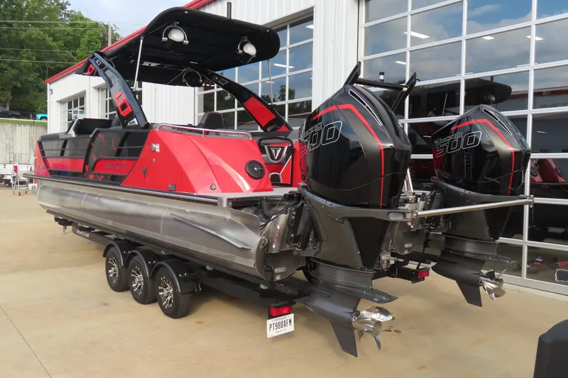 Slide: The Image of 2024 Trifecta 25Sport RF9 DC 3.0 Plus pontoon boat with dual engines, parked outside. - 6