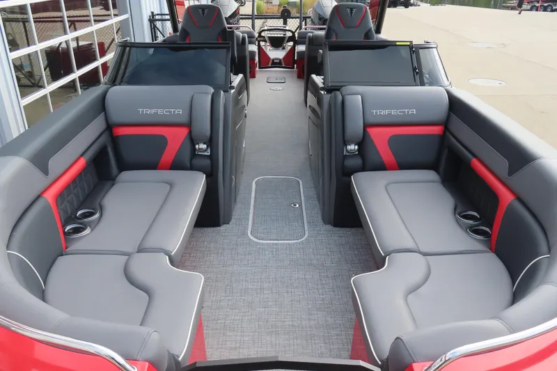 Slide: The Image of 2024 Trifecta 25Sport RF9 DC 3.0 Plus pontoon boat interior with gray and red seating. - 8