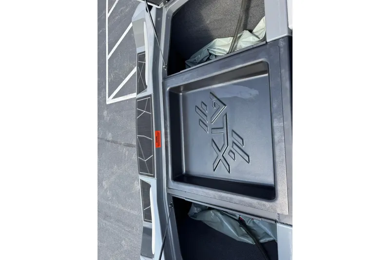 Slide: The Image of 2020 ATX Surf Boats 22 Type-S interior storage compartment with logo detail. - 12