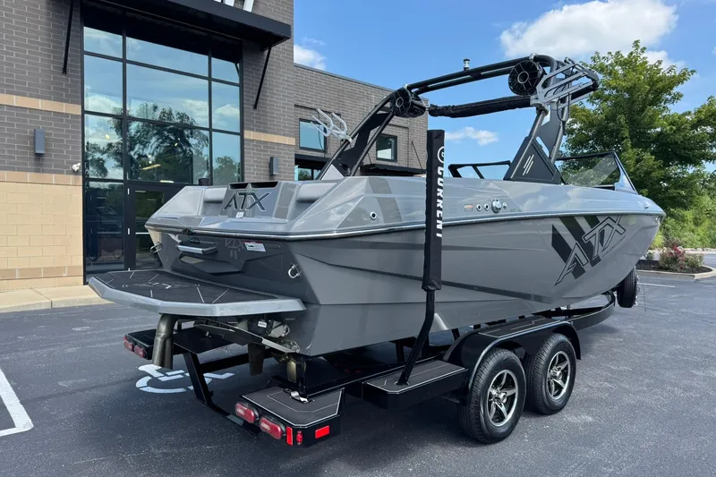 Slide: The Image of 2020 ATX Surf Boats 22 Type-S on trailer, parked outside modern building. - 3