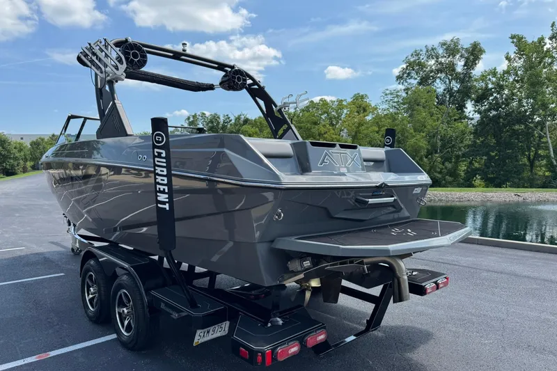 Slide: The Image of 2020 ATX Surf Boats 22 Type-S on trailer, parked near a scenic lake. - 5
