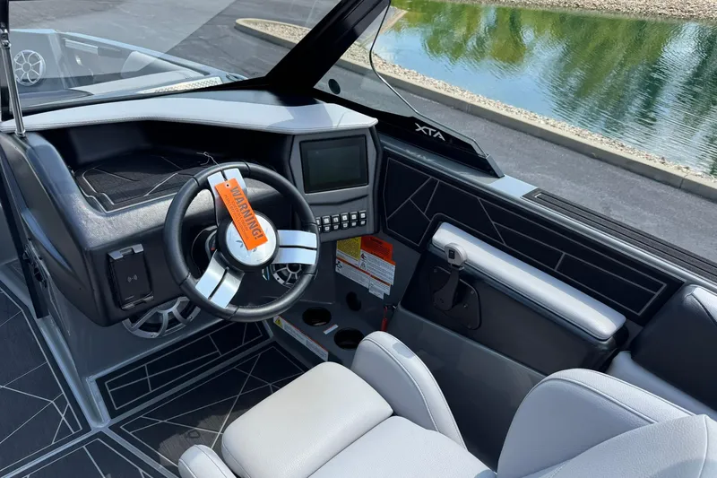 Slide: The Image of 2020 ATX Surf Boats 22 Type-S interior with steering wheel and control panel. - 9