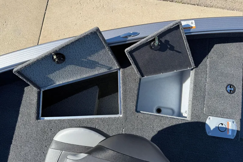 Slide: The Image of 2026 Lund 1875 Pro Guide boat storage compartments with open lids, showcasing interior space. - 13