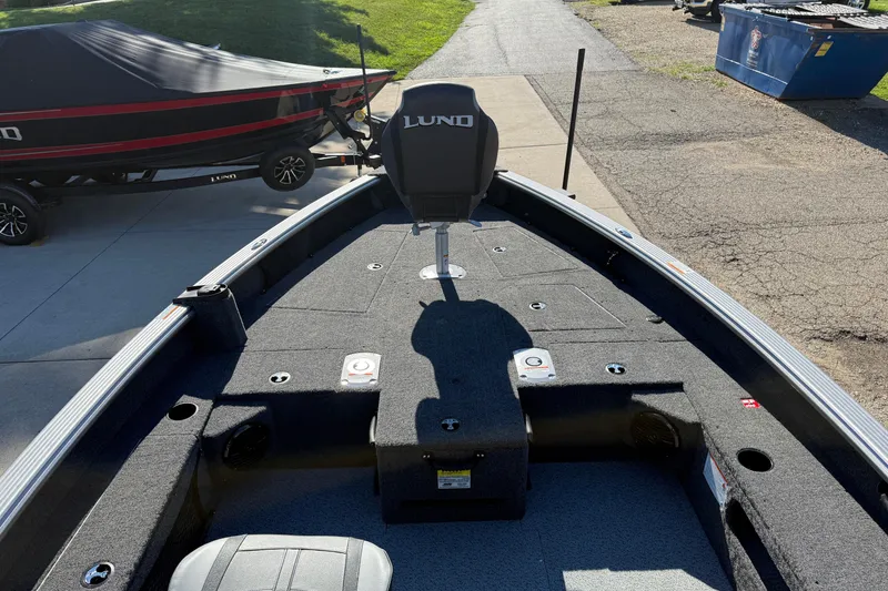 Slide: The Image of 2026 Lund 1875 Pro Guide boat interior with seating and storage compartments. - 16