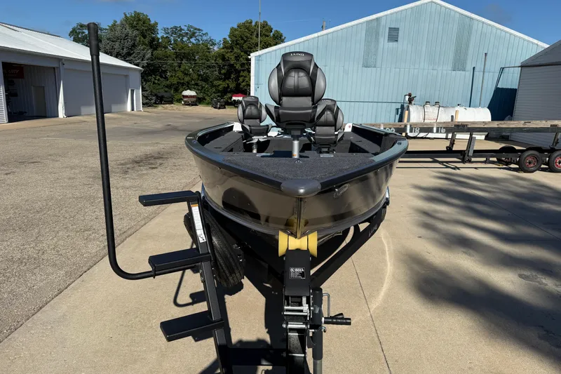 Slide: The Image of 2026 Lund 1875 Pro Guide boat on trailer in outdoor setting. - 2