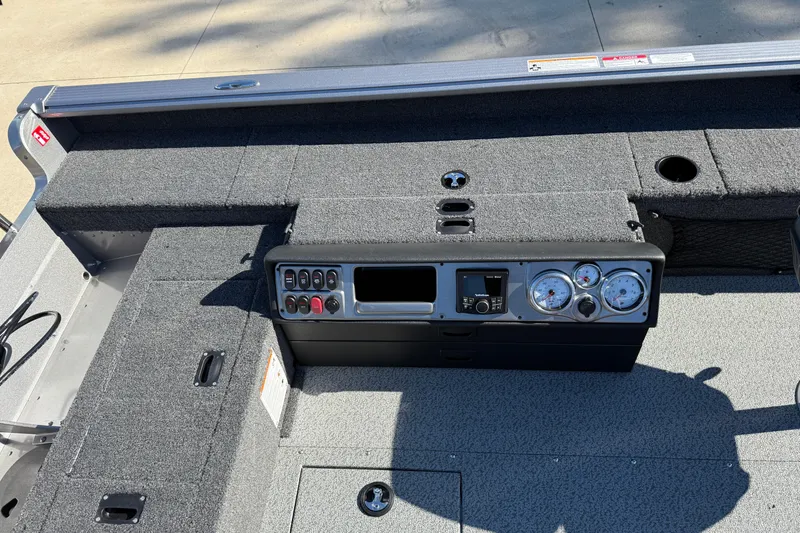 Slide: The Image of 2026 Lund 1875 Pro Guide boat dashboard with gauges and controls, gray interior. - 21