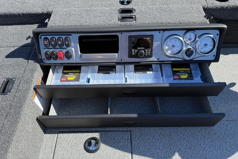 Slide: The Image of 2026 Lund 1875 Pro Guide boat dashboard with storage drawers and control panel. - 22