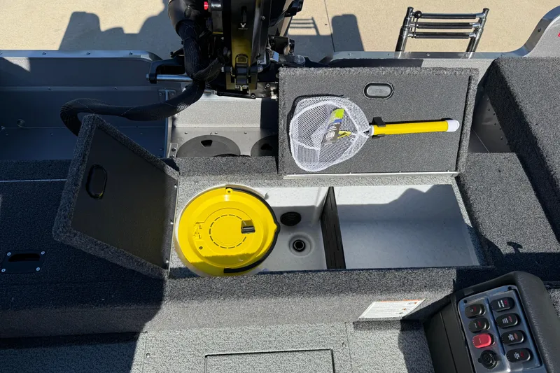 Slide: The Image of 2026 Lund 1875 Pro Guide boat interior with storage compartments and fishing gear. - 23