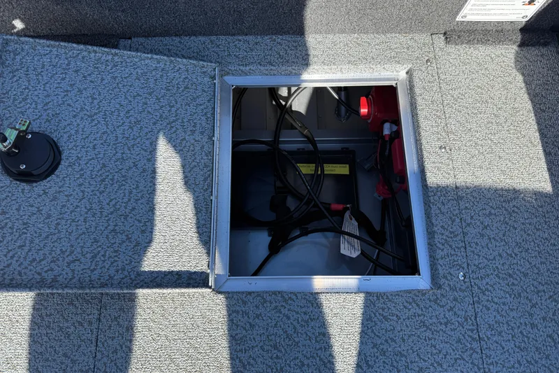 Slide: The Image of Open battery compartment in 2026 Lund 1875 Pro Guide boat, showing wiring and connections. - 24