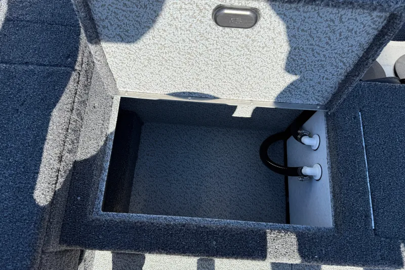 Slide: The Image of Open storage compartment in 2026 Lund 1875 Pro Guide boat, showing interior and plumbing. - 25