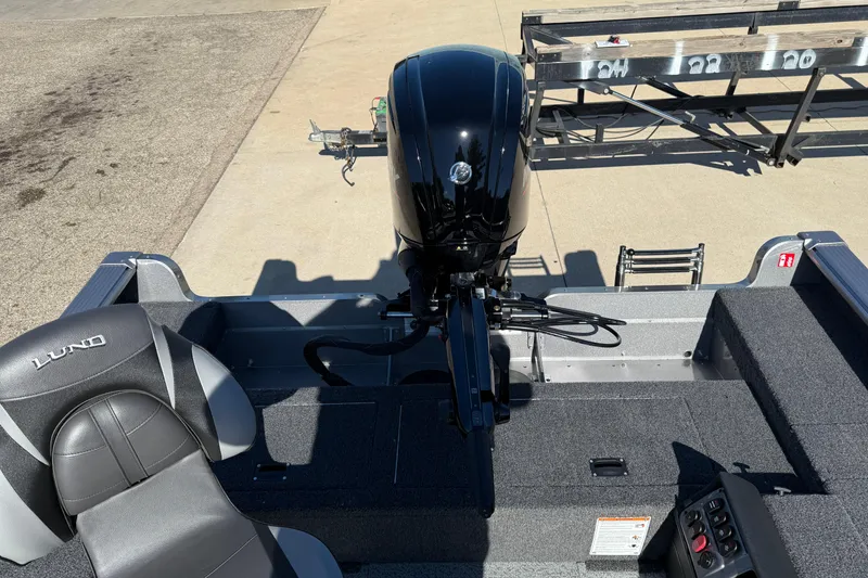 Slide: The Image of 2026 Lund 1875 Pro Guide boat interior with motor and seating. - 26