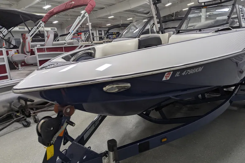 Slide: The Image of 2012 Malibu Wakesetter VLX boat on trailer in showroom setting. - 11