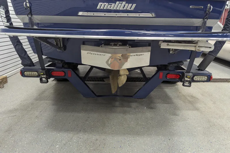 Slide: The Image of Rear view of a 2012 Malibu Wakesetter VLX boat in a garage setting. - 18