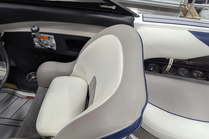 Slide: The Image of 2012 Malibu Wakesetter VLX interior with beige and white seating, cup holders, and control panel. - 22
