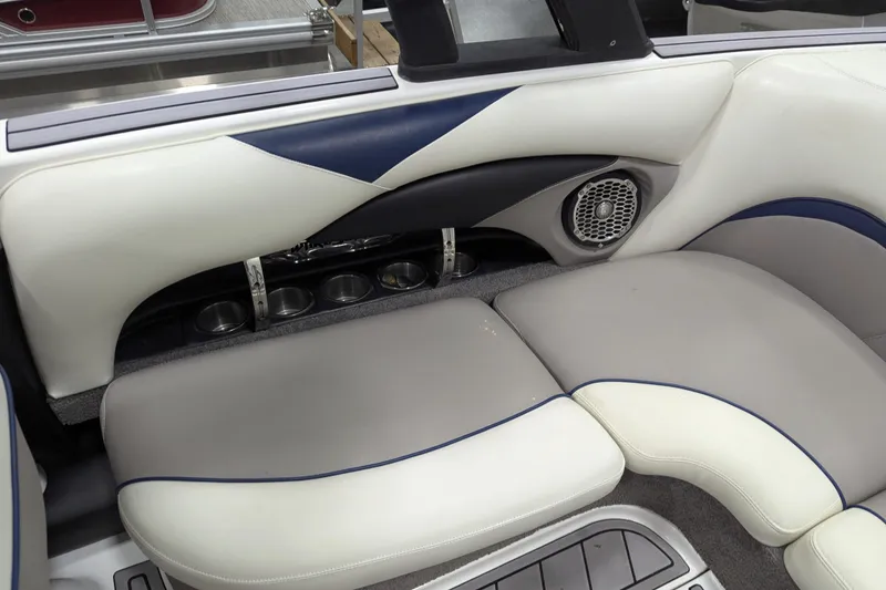 Slide: The Image of 2012 Malibu Wakesetter VLX interior seating with cup holders and speaker. - 30