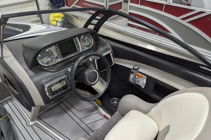 Slide: The Image of 2012 Malibu Wakesetter VLX boat interior with steering wheel and dashboard controls. - 31