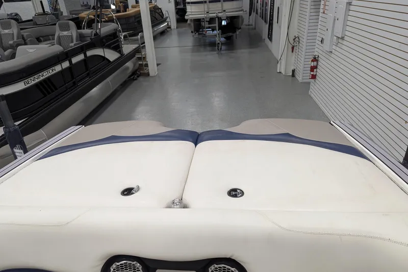 Slide: The Image of 2012 Malibu Wakesetter VLX interior in showroom with other boats. - 32