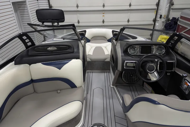 Slide: The Image of Interior of a 2012 Malibu Wakesetter VLX boat, featuring sleek seating and modern dashboard. - 33