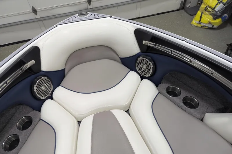 Slide: The Image of 2012 Malibu Wakesetter VLX boat interior with cushioned seating and built-in speakers. - 34