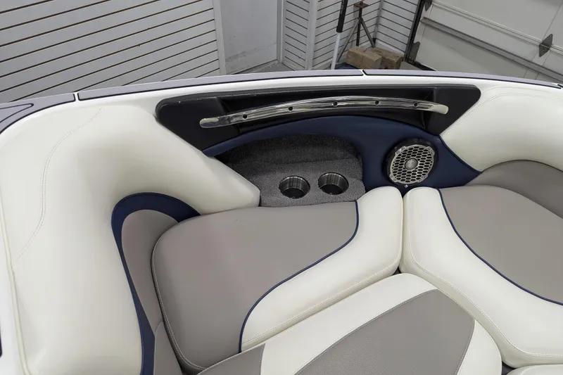 Slide: The Image of 2012 Malibu Wakesetter VLX interior with cushioned seating, cup holders, and speaker. - 36