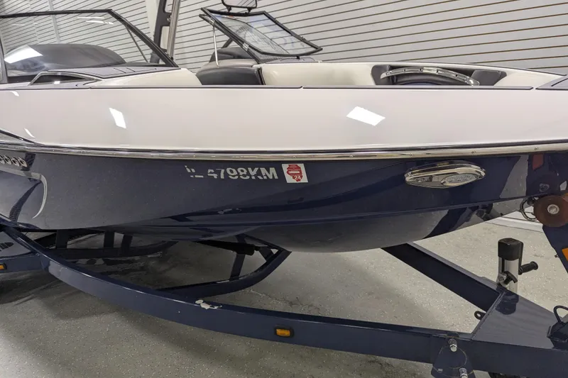 Slide: The Image of 2012 Malibu Wakesetter VLX boat on trailer in showroom. - 9